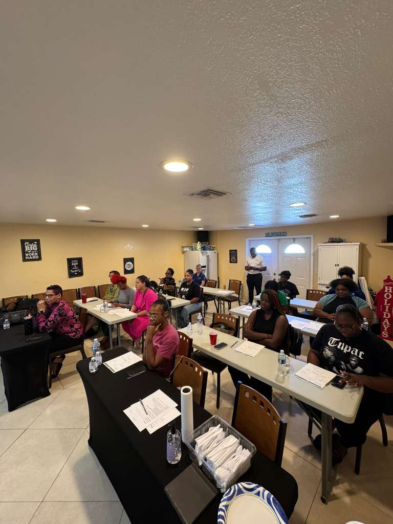 Parents and caregivers participating in the Reading Starts With Us workshop.