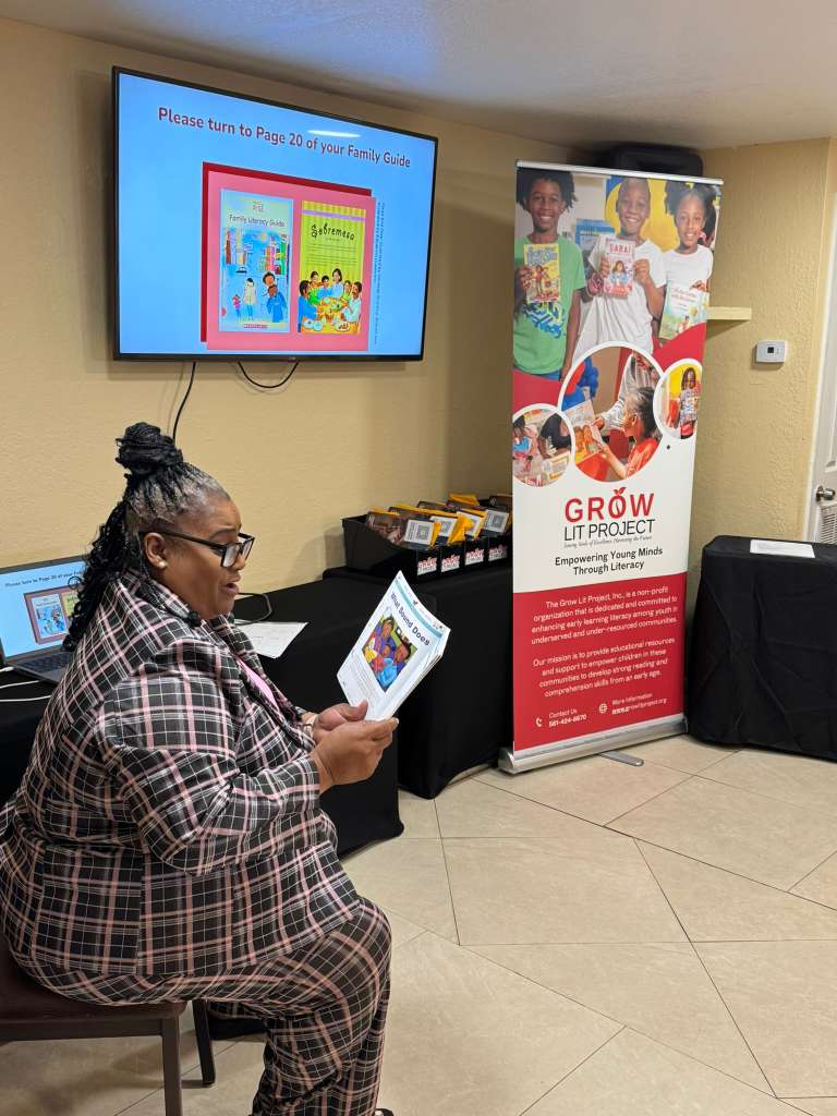 Facilitator leading a guided reading activity using the family literacy handbook.