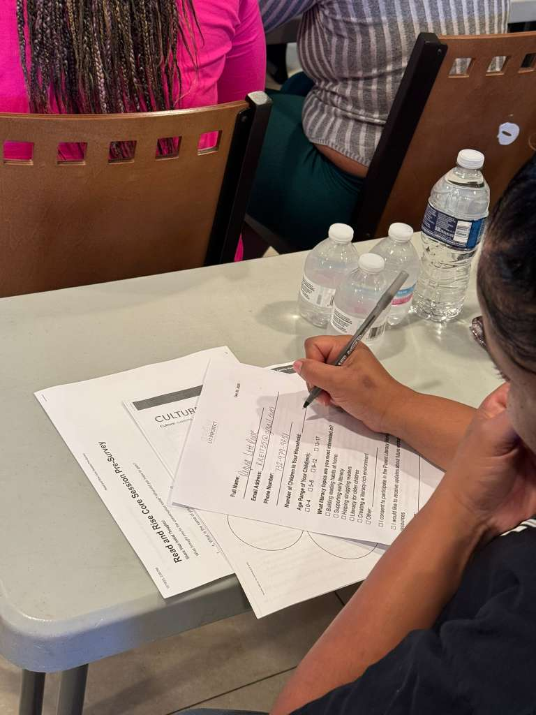Parent completing a literacy planning worksheet during the workshop.